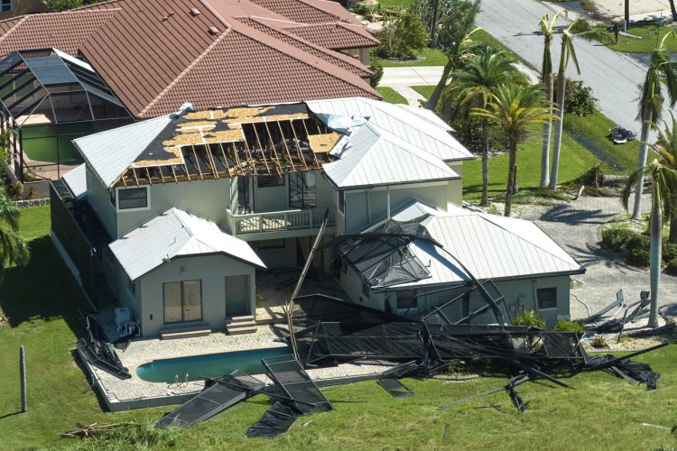 Hurricane Ian destroyed house in Florida residential area. Natural disaster and its consequences.